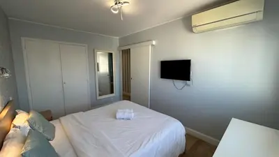 a bedroom with a bed and a tv on the wall at B018-Bright apartment with balcony - Cannes Croisette in Cannes
