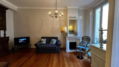 a living room with a couch and a fireplace at B011-Appartement familial - Proche de la plage in Cannes