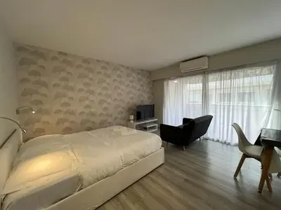 a bedroom with a bed and a desk and a television at B057-Beau studio Carré D'Or & Proche de la Mer Cannes in Cannes