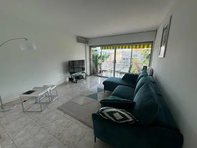a living room with a couch and a table at B049-Appartement lumineux à deux pas de la Croisette in Cannes