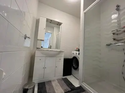 a white bathroom with a sink and a shower at B049-Appartement lumineux à deux pas de la Croisette in Cannes