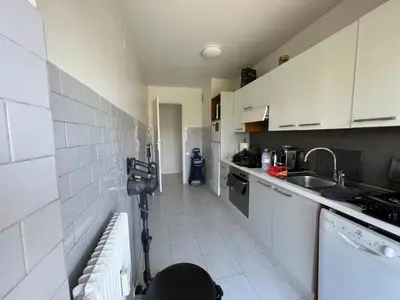 a small kitchen with white cabinets and a sink at B049-Appartement lumineux à deux pas de la Croisette in Cannes