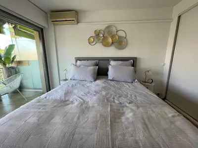a bedroom with a large bed in a room at B049-Appartement lumineux à deux pas de la Croisette in Cannes
