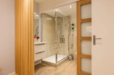 a bathroom with a shower with a glass door at Upscale 3-room apartment 300m from the beaches in Cannes