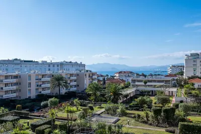 a city with palm trees and buildings at 3-bedroom apartment sea view terrace and parking in Cannes