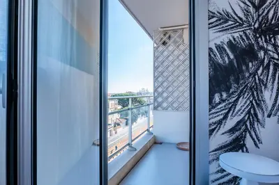 a room with a window with a view of a balcony at 3-bedroom apartment sea view terrace and parking in Cannes