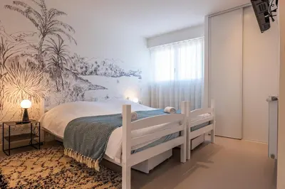 a bedroom with a bed with a mural on the wall at 3-bedroom apartment sea view terrace and parking in Cannes