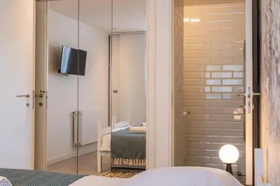 a bedroom with a sliding glass door with a television in it at 3-bedroom apartment sea view terrace and parking in Cannes