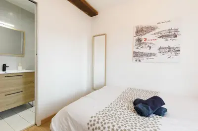 a white bedroom with a bed and a sink at Sweet Azur - Host Provence in Le Cannet