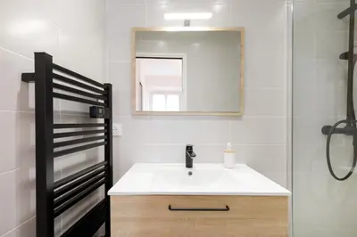 a bathroom with a sink and a mirror at Sweet Azur - Host Provence in Le Cannet