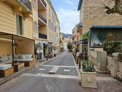 an empty street in a city with buildings at Sweet Azur - Host Provence in Le Cannet