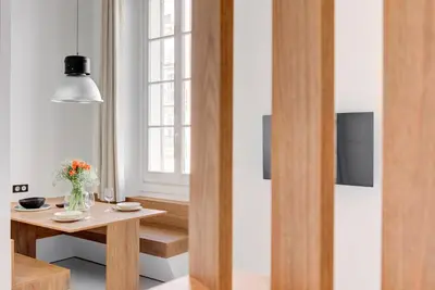 a living room with a table and a window at IMMOGROOM - Appartements luxueux - 2min du Palais - Vue mer - Clim in Cannes