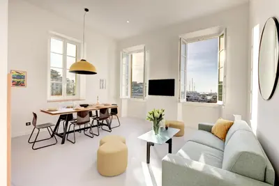 a living room with a couch and a table at IMMOGROOM - Appartements luxueux - 2min du Palais - Vue mer - Clim in Cannes