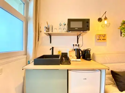 a kitchen counter with a sink and a microwave at Mini-Studio Le Cormoran By SCLS Locations in Cannes