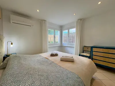 a bedroom with a large bed with two towels on it at Les Jardins de Lérins By SCLS Locations in Cannes