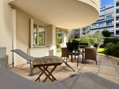 a patio with a table and chairs and a skateboard at Les Jardins de Lérins By SCLS Locations in Cannes