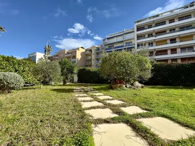 a stone path in a yard with a building at Les Jardins de Lérins By SCLS Locations in Cannes