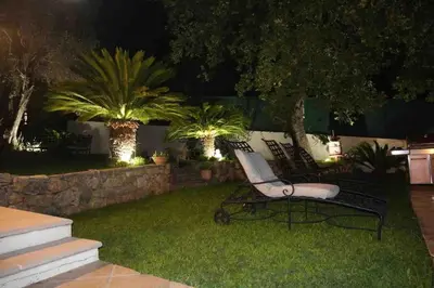 a couple of benches sitting in a yard at night at 10mn de Cannes, villa entière de 150m2. in Le Cannet