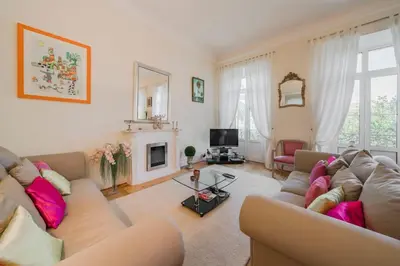 a living room with a couch and a tv at Cozystay 1249 - Gorgeous bourgeois apartment in Cannes