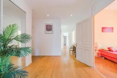 a living room with a bed and a plant at Cozystay 1249 - Gorgeous bourgeois apartment in Cannes