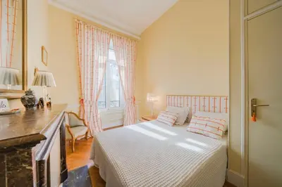 a small bedroom with a bed and a window at Cozystay 1249 - Gorgeous bourgeois apartment in Cannes
