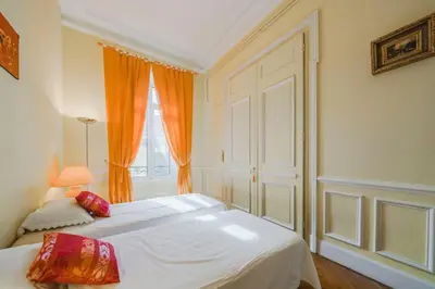 a bedroom with a white bed and a window at Cozystay 1249 - Gorgeous bourgeois apartment in Cannes