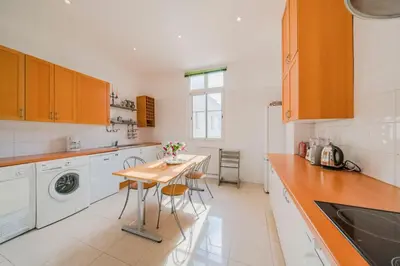 a kitchen with a table and a washing machine at Cozystay 1249 - Gorgeous bourgeois apartment in Cannes