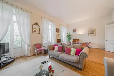 a living room with a couch and a tv at Cozystay 1249 - Gorgeous bourgeois apartment in Cannes