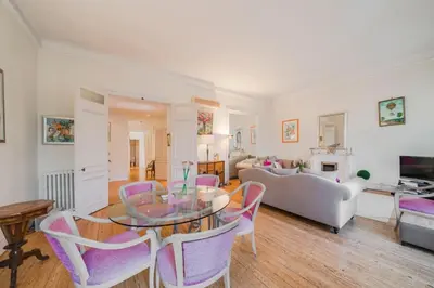 a living room with a glass table and chairs at Cozystay 1249 - Gorgeous bourgeois apartment in Cannes