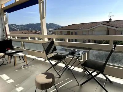 a balcony with a table and chairs on a building at AGENCIA Superbe appartement Le Bellevue in Cannes