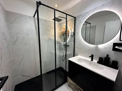 a bathroom with a shower and a sink and a mirror at AGENCIA Superbe appartement Le Bellevue in Cannes