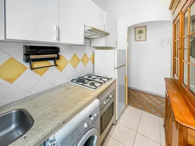 a kitchen with a stove top oven next to a sink at Chic Cannois Proche de la Croisette in Cannes
