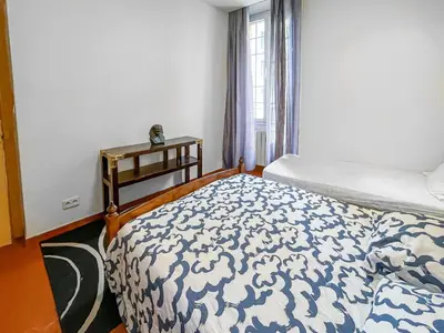 a bedroom with a bed and a window at Chic Cannois Proche de la Croisette in Cannes