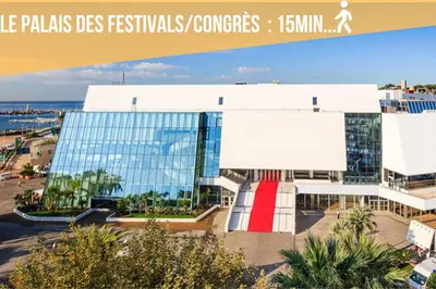 a large building with a red door in front of it at Chic Cannois Proche de la Croisette in Cannes