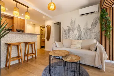 a living room with a couch and a table at LA VILLA BALI A CANNES in Cannes