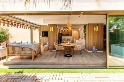 a patio with a table and chairs on a deck at LA VILLA BALI A CANNES in Cannes