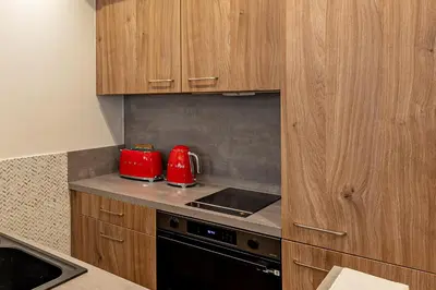 a kitchen with two red appliances on a counter at LA VILLA BALI A CANNES in Cannes