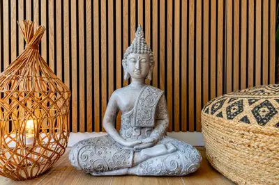 a statue sitting on a table next to a lamp at LA VILLA BALI A CANNES in Cannes