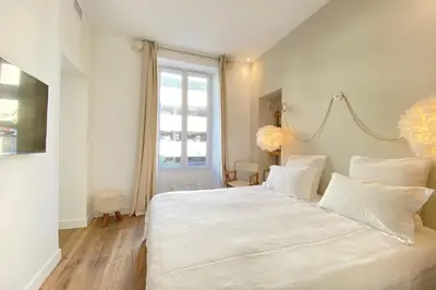 a bedroom with a large white bed with white pillows at Beautiful 2 bedrooms 2 bathrooms Center of Cannes in Cannes