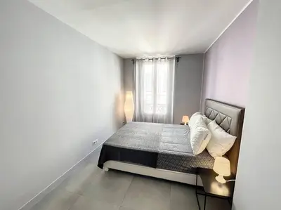 a small bedroom with a bed and a window at BAT2 - Cannes, Carré d'Or, beau 2 pièces in Cannes