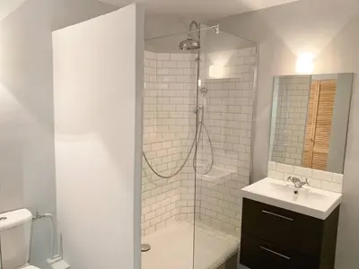 a white bathroom with a shower and a sink at BAT2 - Cannes, Carré d'Or, beau 2 pièces in Cannes