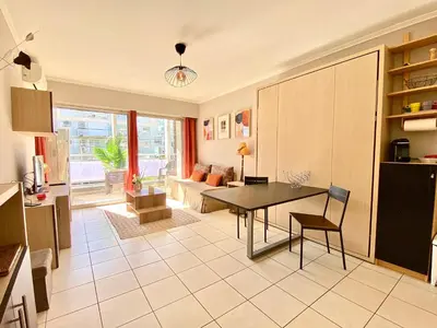 a kitchen and living room with a table and a couch at Terracotta - Proche Palais des Festivals - By SCLS Locations in Cannes