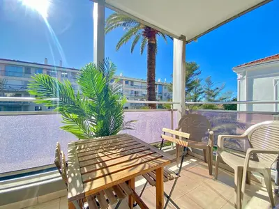 a patio with chairs and a table and a palm tree at Terracotta - Proche Palais des Festivals - By SCLS Locations in Cannes
