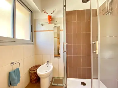 a small bathroom with a toilet and a shower at Terracotta - Proche Palais des Festivals - By SCLS Locations in Cannes