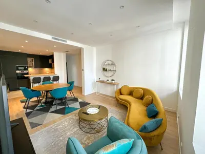 a living room with a couch and a table at Appartements Centre Cannes in Cannes