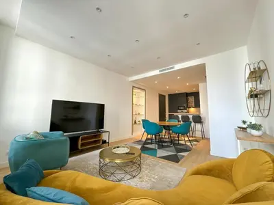a living room with a couch and a tv at Appartements Centre Cannes in Cannes