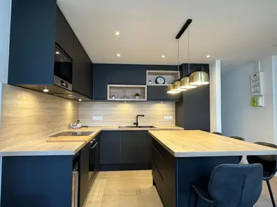 a kitchen with blue cabinets and a counter top at Appartements Centre Cannes in Cannes