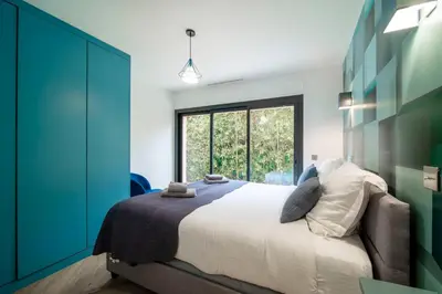 a bedroom with a bed and a large window at REF 2134 - Cannes - Magnificent villa for rent in Cannes