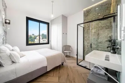 a bedroom with a bed and a sink and a shower at REF 2134 - Cannes - Magnificent villa for rent in Cannes