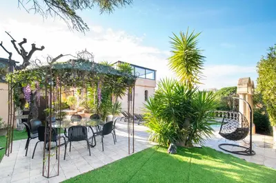 a patio with a table and chairs in a yard at REF 2134 - Cannes - Magnificent villa for rent in Cannes